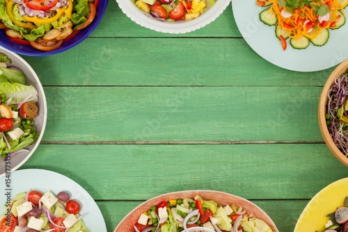 Various fresh food on green wooden table