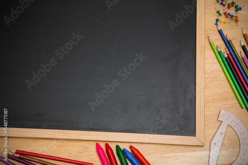 Displaying vector top down wooden chalkboard on desk showing colored pencils, push pins, protractor