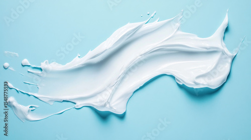 White moisturizing lotion smeared against a blue background, illustrating product texture for cosmetic trials or skincare promotions. 