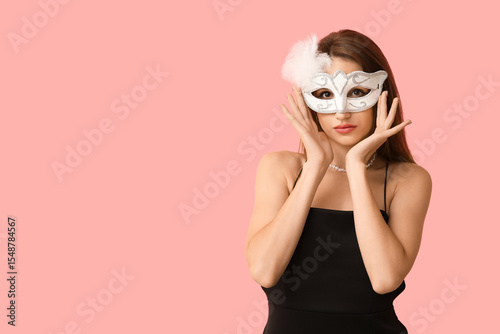 Elegant woman in white masq...