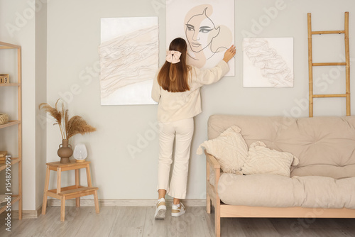 Young woman hanging stylish...