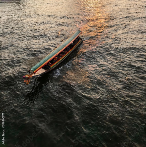 Traditional Thai Longtail Boat on River at Sunset