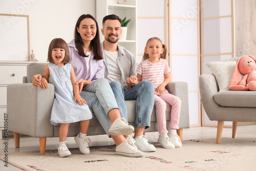 Beautiful happy family sitt...