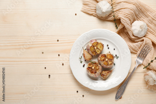 Wallpaper Mural Plate with baked garlic, peppercorns and thyme on light wooden background Torontodigital.ca