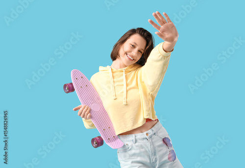 Young woman with skateboard...