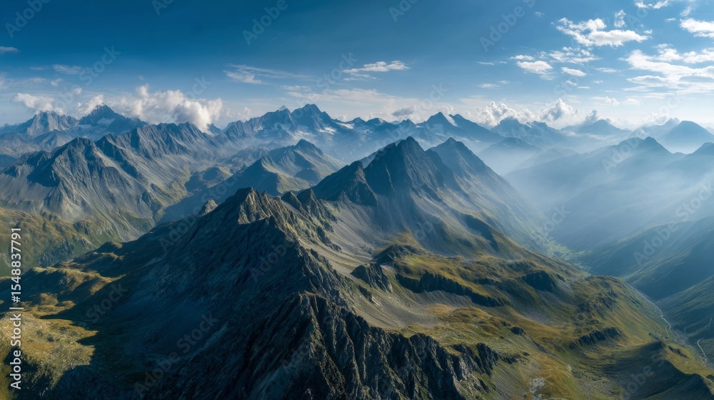 Fototapeta premium Majestic mountain range at sunrise with expansive valleys and cloudy sky