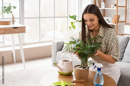 Young woman with palm plant...