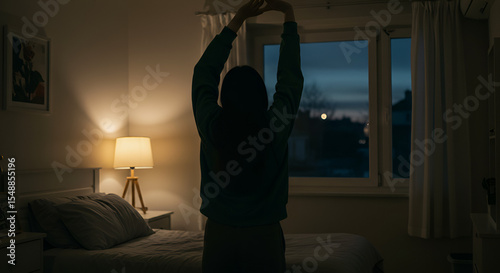 Woman Stretching in Bedroom at Twilight, Embracing a Peaceful Morning Routine