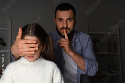 Father showing silence gest...
