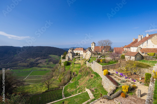 Panoramic view of Chateau Chalon perched on a cliff overlooking vineyards, in Jura, France photo