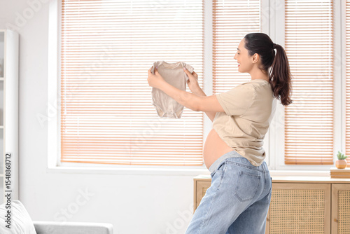 Expectant mother holding ba...