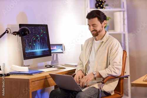 Handsome man working with l...