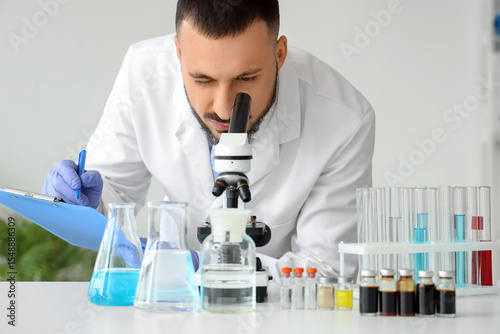 Male scientist with clipboa...