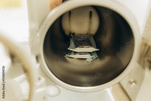 Sterilizing medical instruments in autoclave ensures hygiene in healthcare settings photo