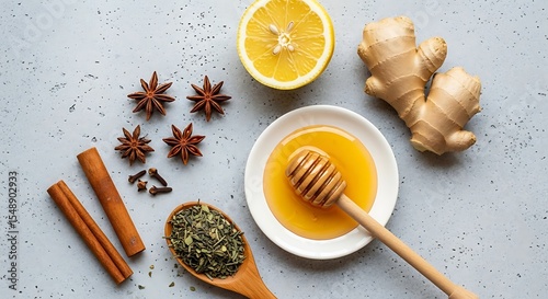 Fototapeta Naklejka Na Ścianę i Meble -  Ingredients for herbal tea with ginger honey lemon and various spices on a gray surface.