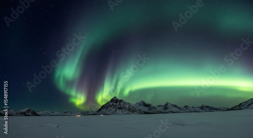 Stunning Aurora Borealis Display over Snowy Mountains and Frozen Lake at Night
