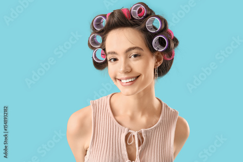 Young woman with hair curle...