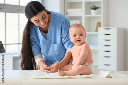 Female therapist massaging ...