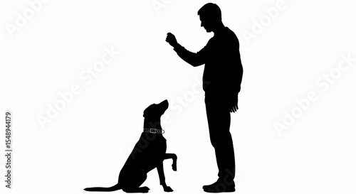 Silhouette of a man training a dog to give a paw against a white background in a studio setting