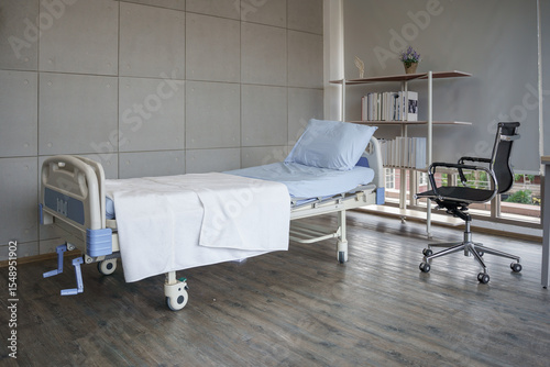 Empty hospital room with a patient bed and a wheelchair by the window, conveying recovery or disability. Clean and modern healthcare facility interior for a nursing home, hospital