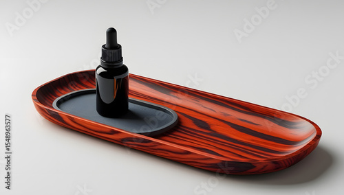 Black glass dropper bottle on red wooden tray