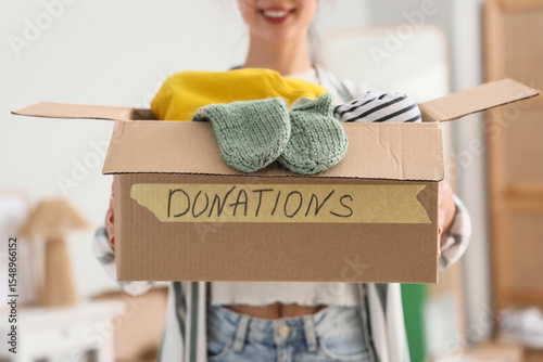 Young woman holding box wit...