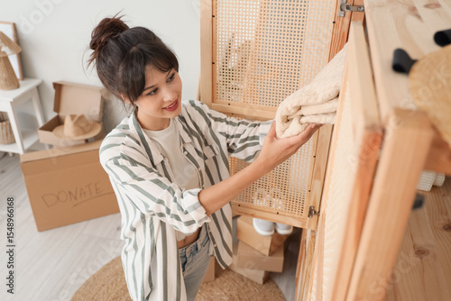 Young woman packing clothes...