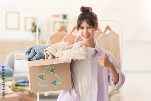Young woman with box of clo...