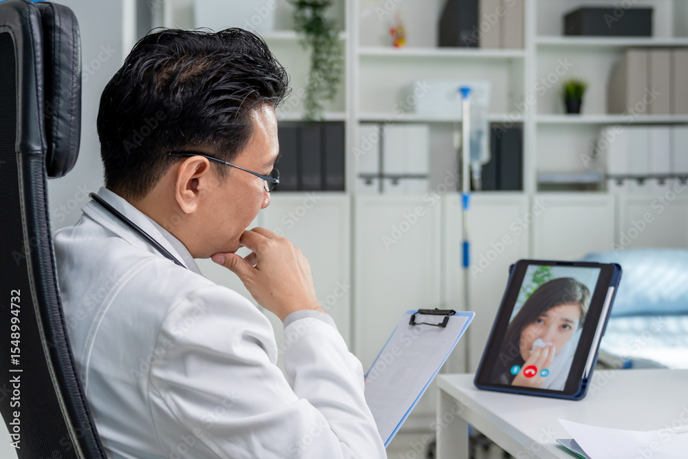 Fototapeta premium Asian doctor providing telehealth video consultation to online patient. 
