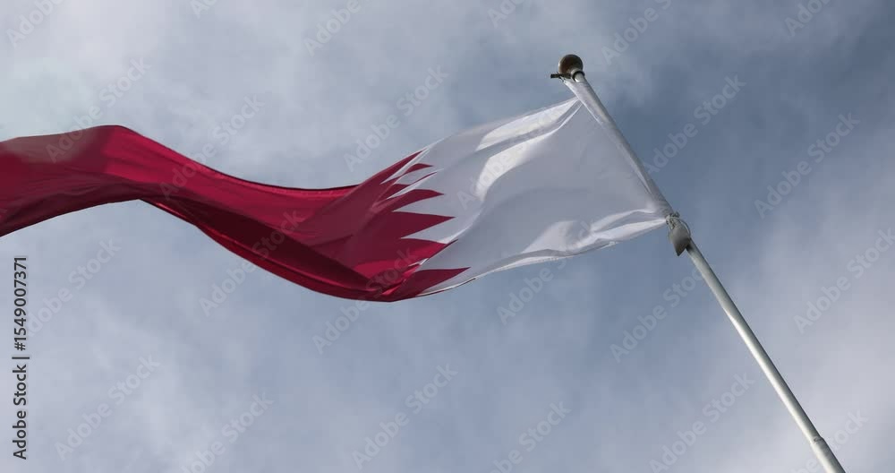 Video from the Qatar Flag in 4K format. The flag of Qatar, waving against the background of the blue sky, is the national symbol of Qatar. Independence Day. The flag is in close-up. Great for news.
