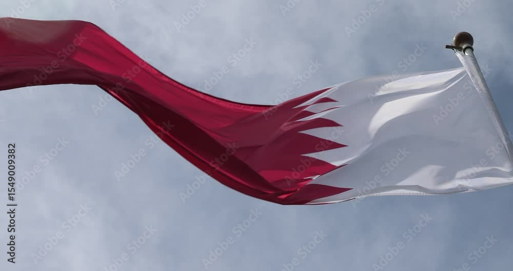 Video from the Qatar Flag in 4K format. The flag of Qatar, waving against the background of the blue sky, is the national symbol of Qatar. Independence Day. The flag is in close-up. Great for news.