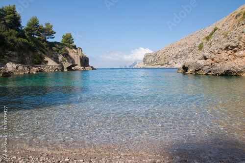 Fototapeta Naklejka Na Ścianę i Meble -  Ieranto bay on the Amalfi Coast in front of the Capri faraglioni, Southern Italy