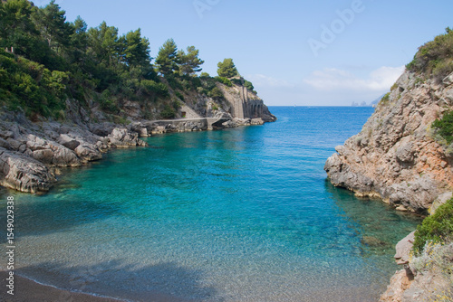 Ieranto bay on the Amalfi Coast in front of the Capri faraglioni, Southern Italy