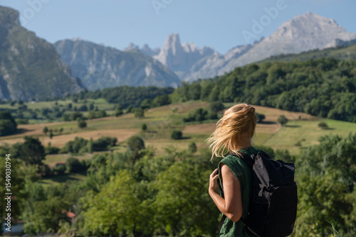 Woman standing on the rock with a backpack