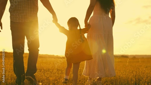 happy family park. little kid daughter runs across meadow sunset. mother father kid child travel together. childhood dream run and play. family walk sunshine. cheerful child holds mom dad by hand.