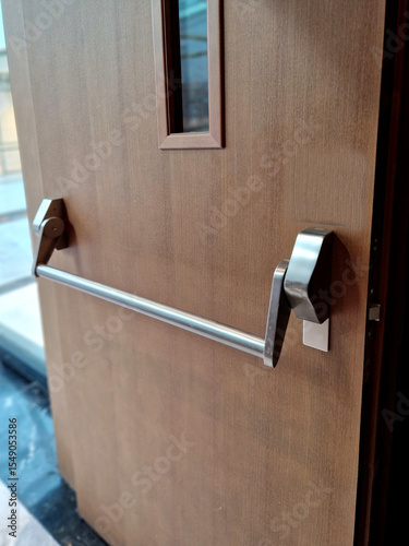 rear door of department store or warehouse with handle for quick release of door. evacuation door handle, panic fire button. in dangerous crush, all you have to do is lean horizontal pushing