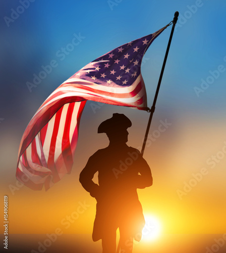 Obraz na plátně Waving US flag and Revolutionary War soldier against sunset