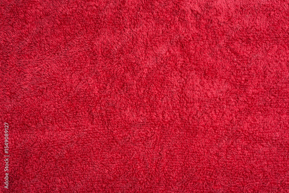Fototapeta premium Close-up of a red terrycloth towel, showcasing its soft, plush texture and vibrant color
