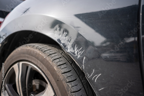 Car fender with dog bite scratches and paint damage