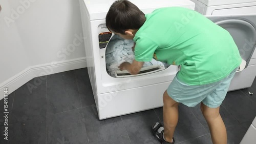 young boty teenager doing laundry