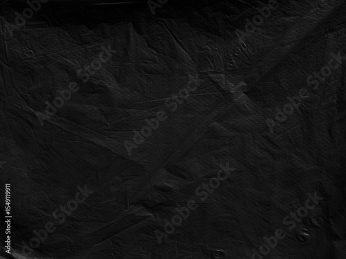 Black background plastic wrinkle bag film glossy crumpled overlay package rough wrap material pack reflection texture floor packaging retail grain pollution trash polyethylene, halloween backdrop.