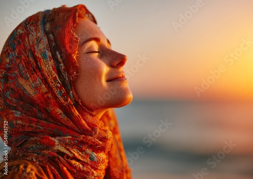 Peaceful Woman in Red Headscarf at Sunset Beach