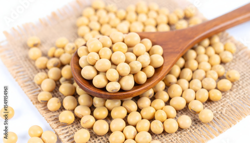 Soybeans: A wooden spoon cradles a mound of creamy, wholesome soybeans, inviting a close-up exploration of their natural texture and form. Embodying the essence of fresh, unprocessed ingredients.
