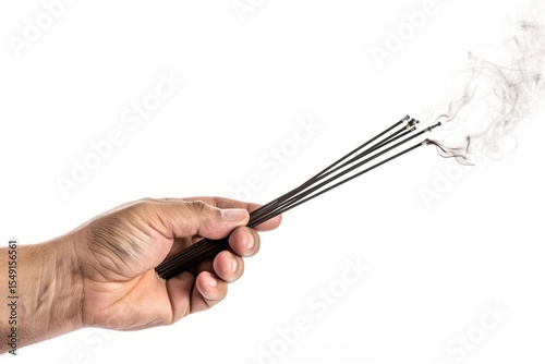 Hand holding set of smoldering chopsticks food smoke pipe.