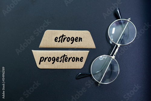 sticks with the words estrogen and progesterone. concept of female hormones and menopause photo