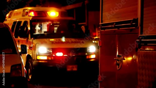 ambulance car responding to accident turning on siren red and blue light at night street