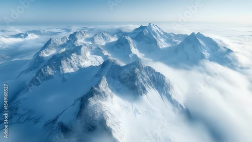 Snow Capped Mountain Range Above Cloud Layer Under a Clear Blue Sky in Winter