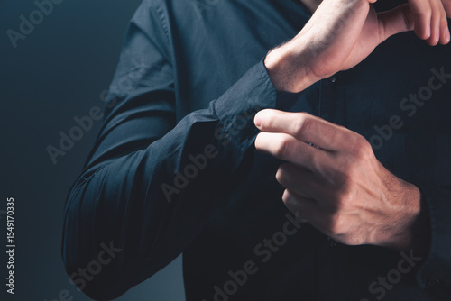 close - up of a man 's hand in a black shirt