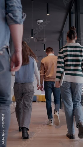 Business team in a modern open space startup office walking together. Diverse group of businesspeople smiling while having a discussion. Successful mixed race colleagues collaborating on a new project