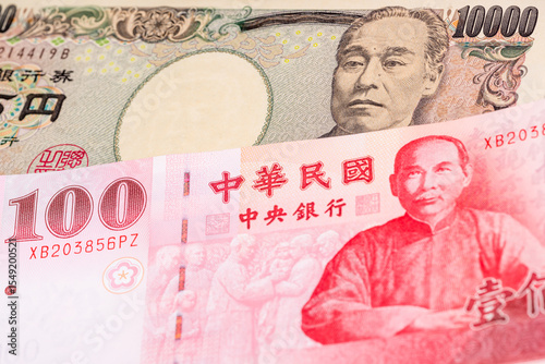 Wallpaper Mural 10000 Japanese yen and 100 New Taiwan dollar banknotes. International trade concept Torontodigital.ca